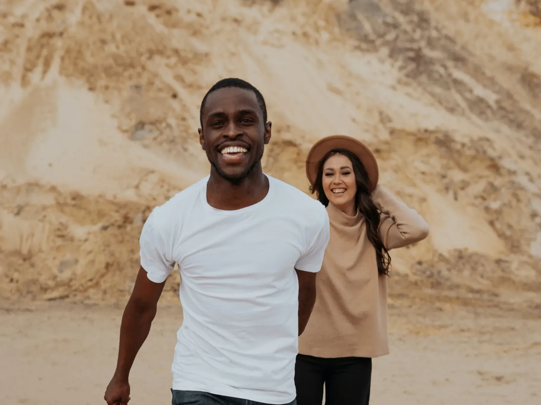 A smiling couple standing together outdoors